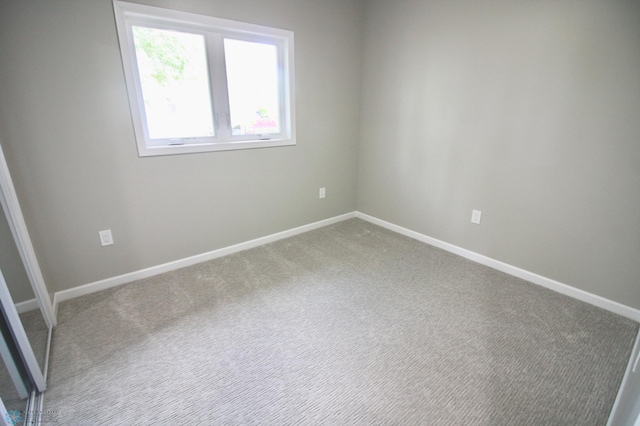 501 1st St NE, Hankinson, ND 58041 - spare room with baseboards and carpet
