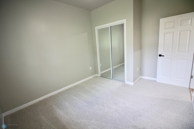 501 1st St NE, Hankinson, ND 58041 - unfurnished bedroom with light carpet, a closet, and baseboards