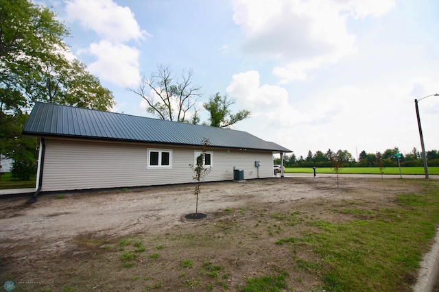 501 1st St NE, Hankinson, ND 58041 - rear view of property with central AC unit and metal roof