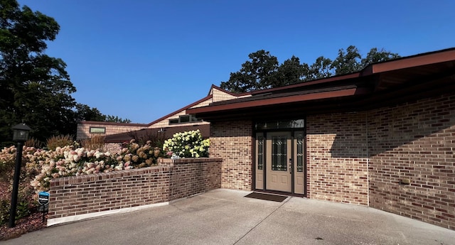 property entrance featuring a patio area