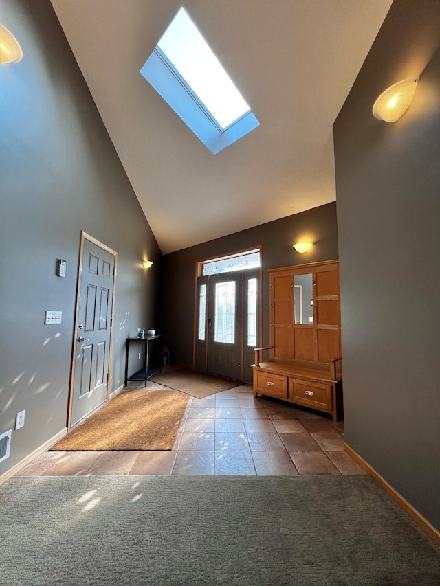 entrance foyer featuring electric panel, a skylight, high vaulted ceiling, and carpet flooring