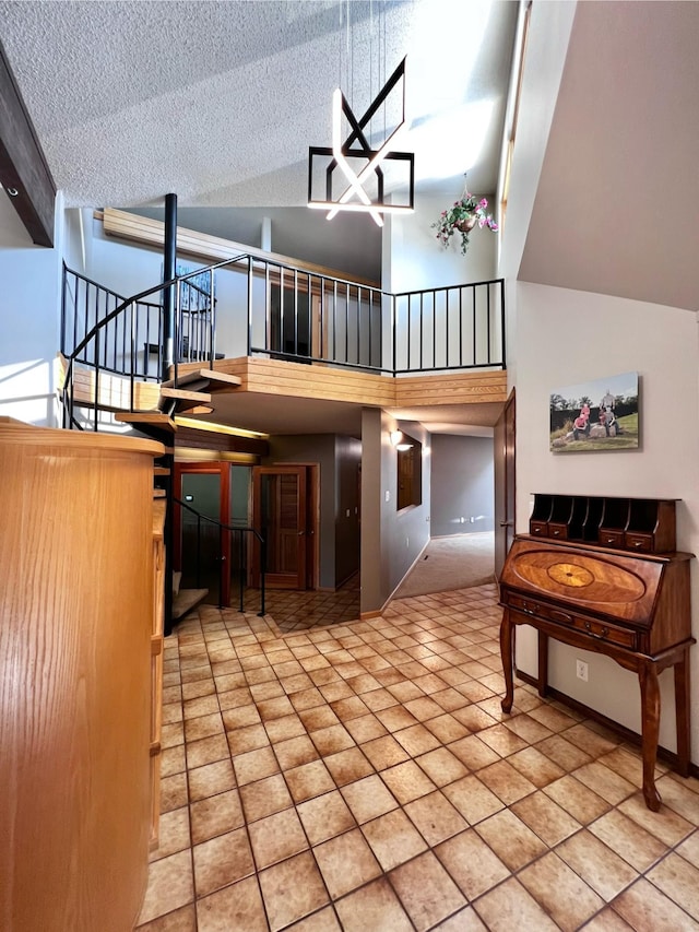 interior space with tile patterned flooring, a textured ceiling, and a high ceiling