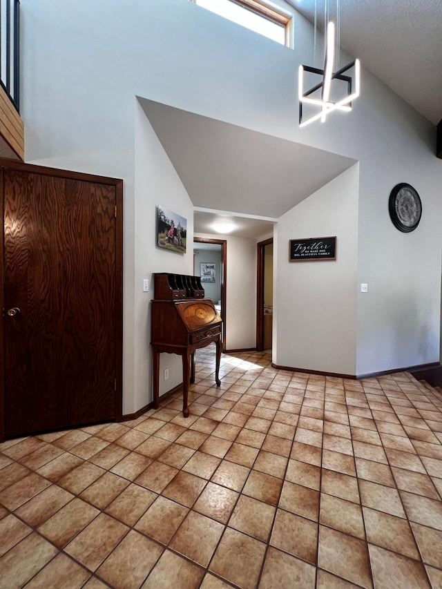 tiled entryway featuring an inviting chandelier