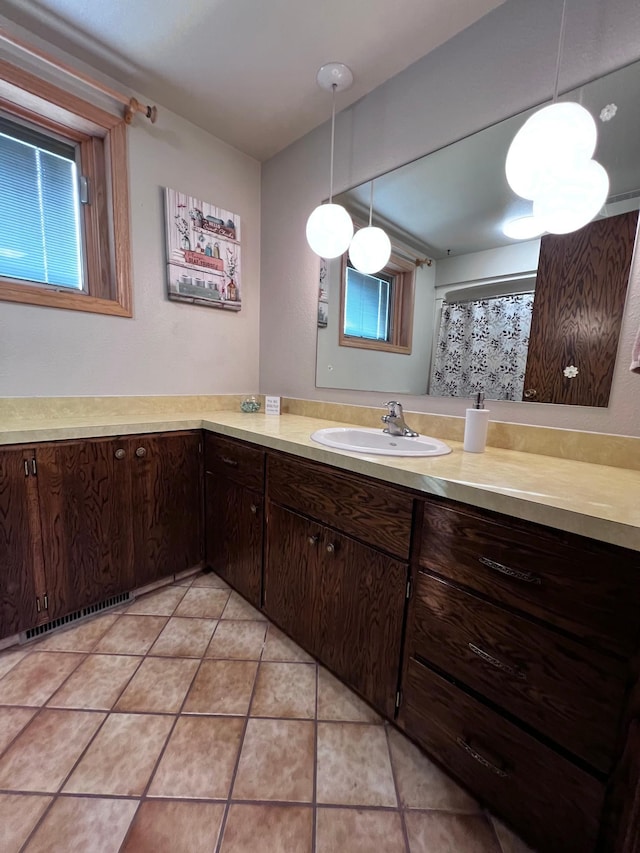 bathroom featuring tile patterned flooring and vanity