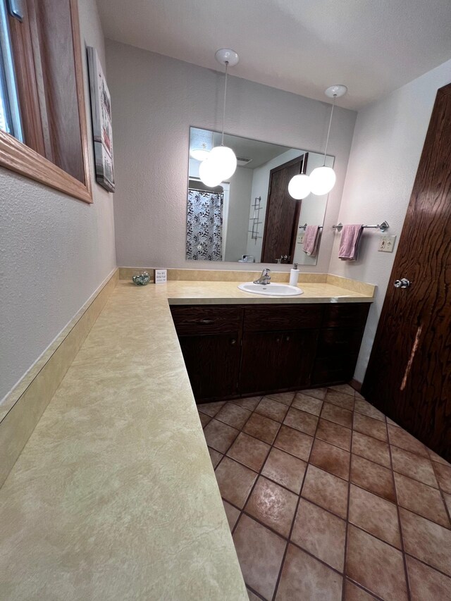 bathroom with tile patterned floors and vanity