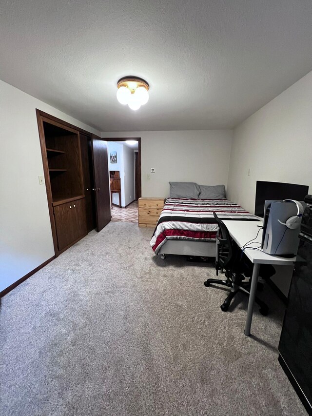 bedroom featuring carpet floors and a textured ceiling