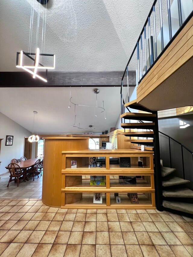 stairway with tile patterned flooring and a textured ceiling