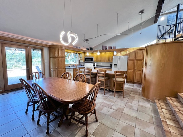 dining room featuring light tile patterned flooring, sink, and high vaulted ceiling