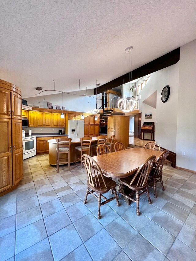 tiled dining space featuring a textured ceiling