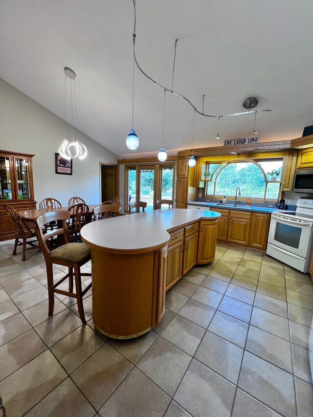 kitchen with a kitchen island, lofted ceiling, light tile patterned flooring, and white electric range