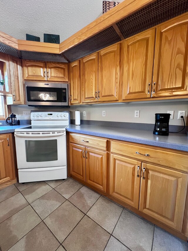 kitchen featuring white range with electric cooktop and light tile patterned floors