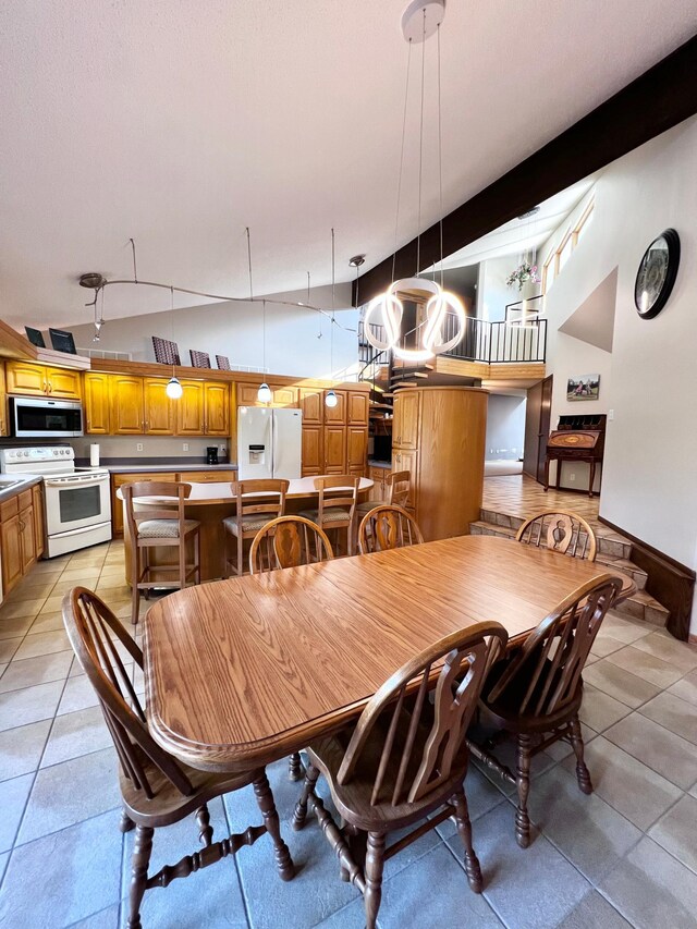 dining room with light tile patterned floors and rail lighting