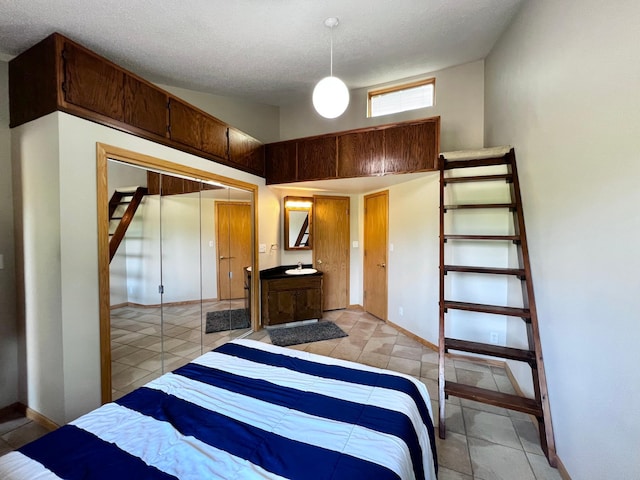 bedroom with light tile patterned floors, a closet, and a textured ceiling