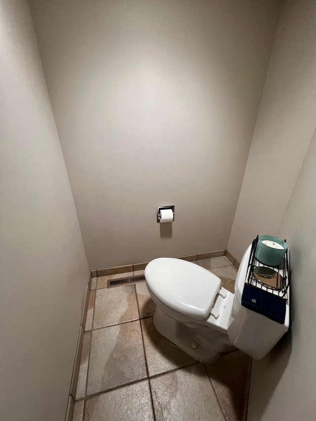 bathroom with toilet and tile patterned flooring