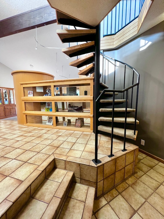 stairs featuring tile patterned flooring, lofted ceiling, and a textured ceiling