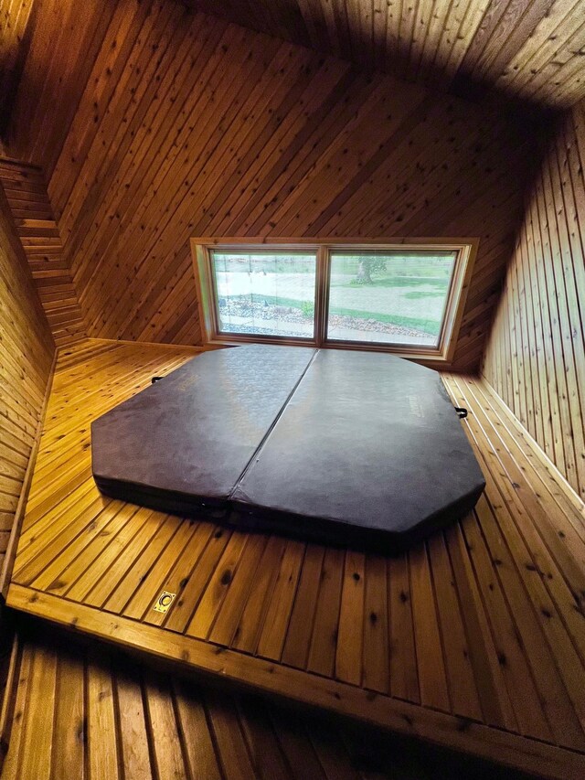 view of sauna / steam room featuring wooden walls, hardwood / wood-style floors, and wood ceiling