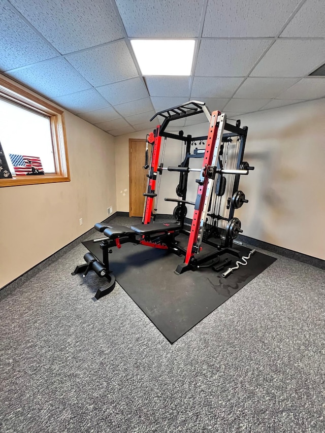 workout area featuring a paneled ceiling