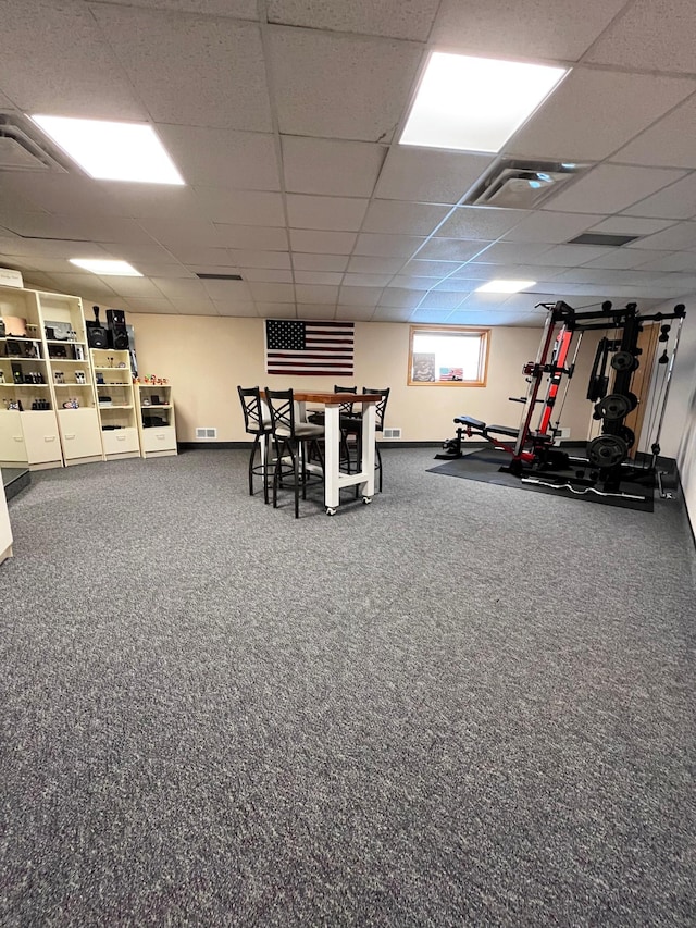 interior space with a drop ceiling and carpet floors