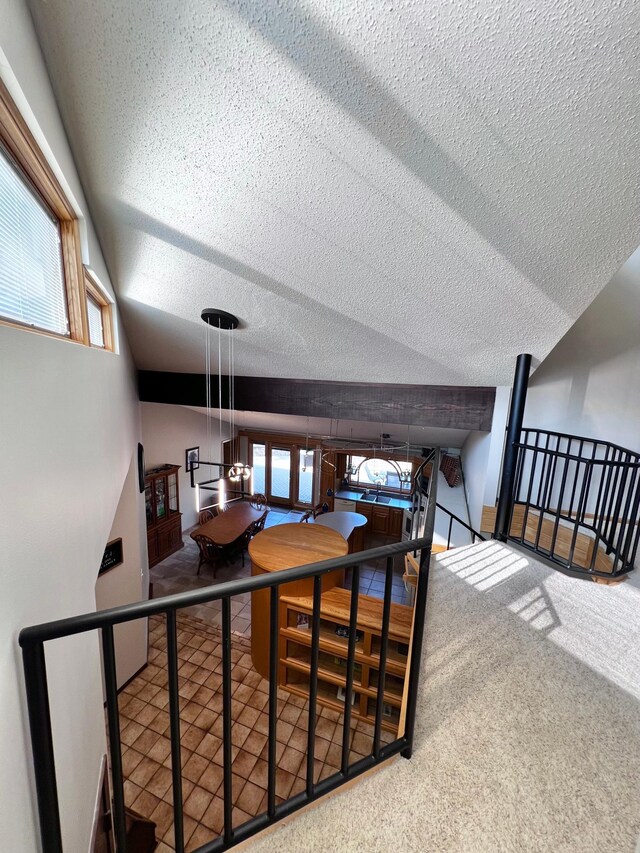 interior space with a textured ceiling and lofted ceiling