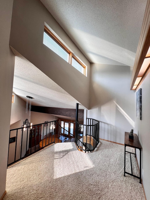 bonus room with carpet, high vaulted ceiling, and a textured ceiling