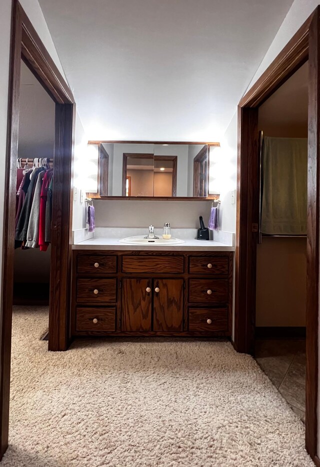 bathroom featuring lofted ceiling, vanity, and tile patterned floors