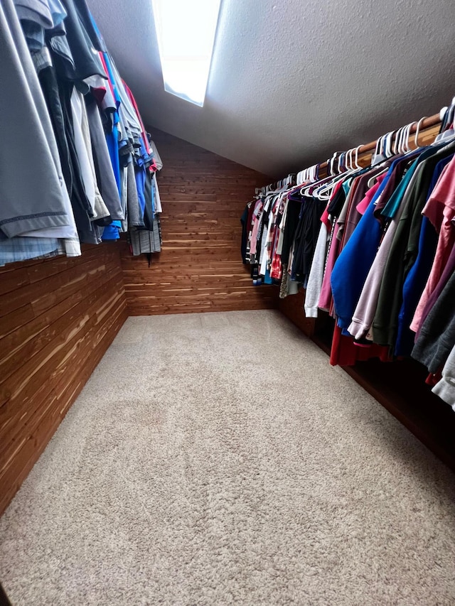 spacious closet featuring carpet floors and lofted ceiling