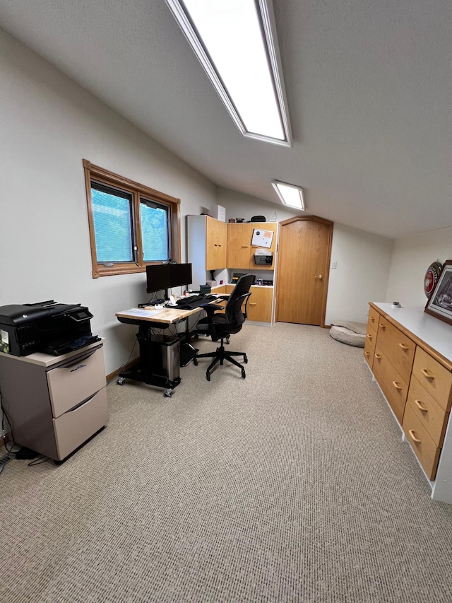 office featuring vaulted ceiling, a textured ceiling, and light colored carpet