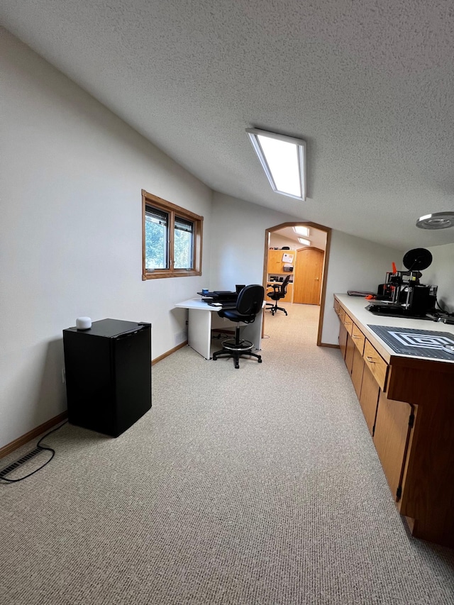 carpeted office with a textured ceiling