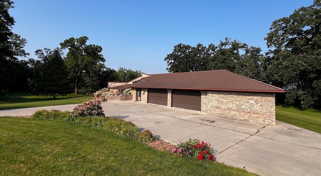 view of side of home featuring a yard and a garage