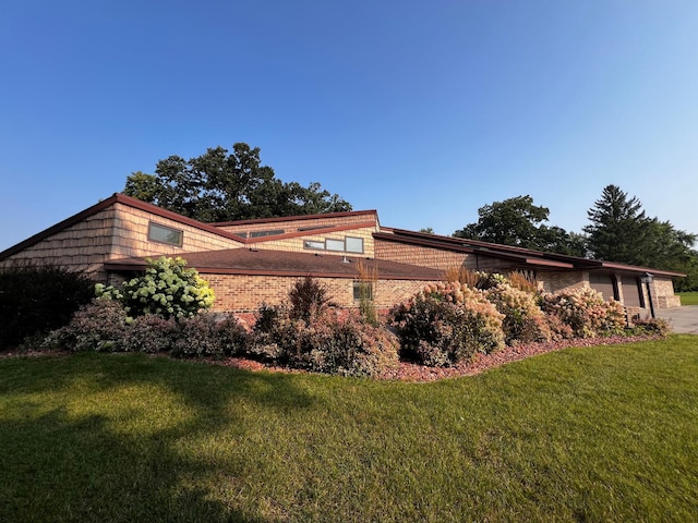 view of home's exterior featuring a yard and a garage