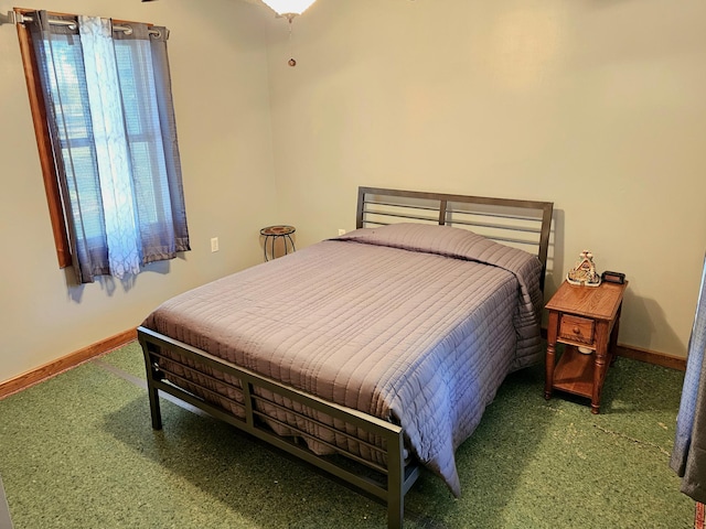 bedroom featuring baseboards and carpet flooring