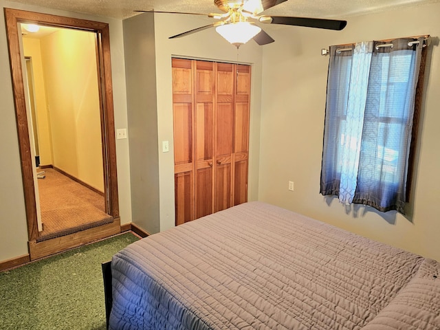 bedroom with a closet, a textured ceiling, a ceiling fan, and baseboards