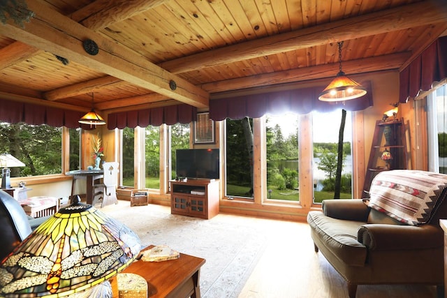 living area with wood ceiling, beamed ceiling, and a healthy amount of sunlight