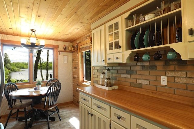kitchen with open shelves, decorative light fixtures, wood ceiling, a chandelier, and glass insert cabinets