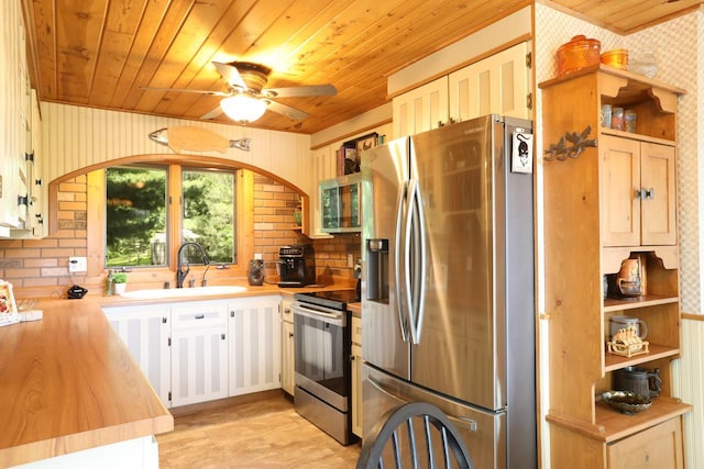 kitchen with wood ceiling, stainless steel appliances, a ceiling fan, and arched walkways