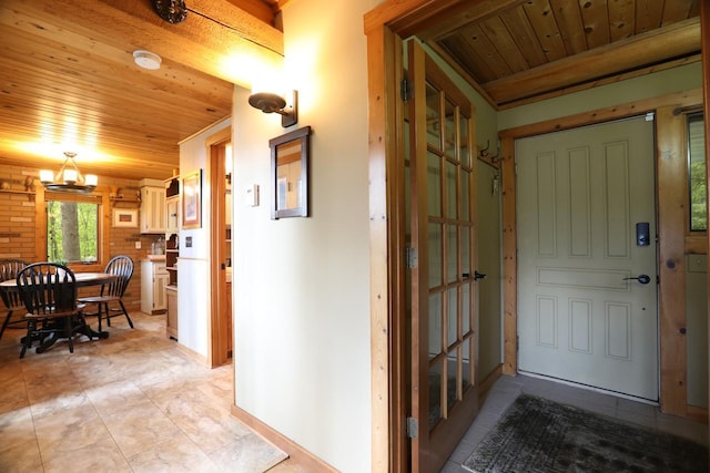 interior space with wood ceiling, baseboards, a chandelier, and light tile patterned floors