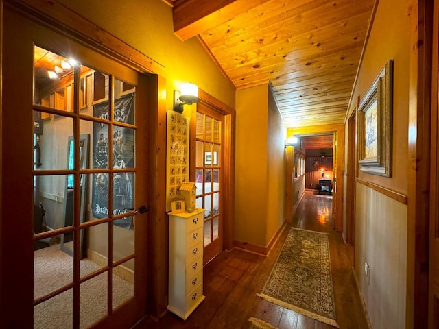 hallway with french doors, vaulted ceiling, baseboards, wood ceiling, and hardwood / wood-style flooring