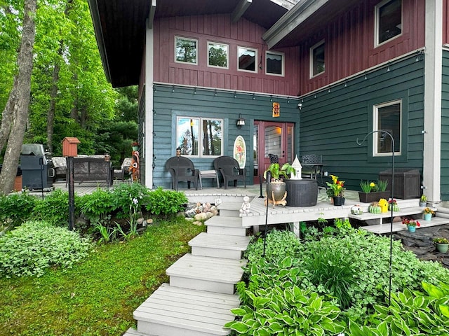 back of house featuring board and batten siding and a patio area