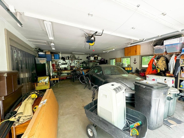 garage with a garage door opener and a workshop area