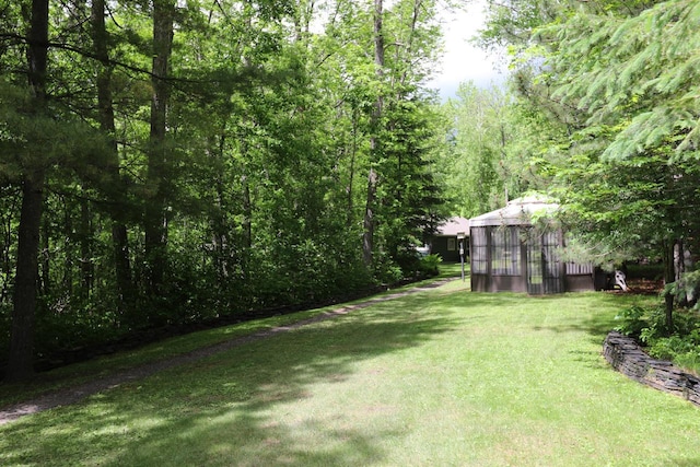 view of yard with a view of trees