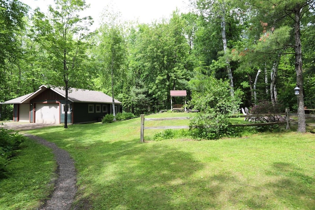 view of yard with driveway and a garage