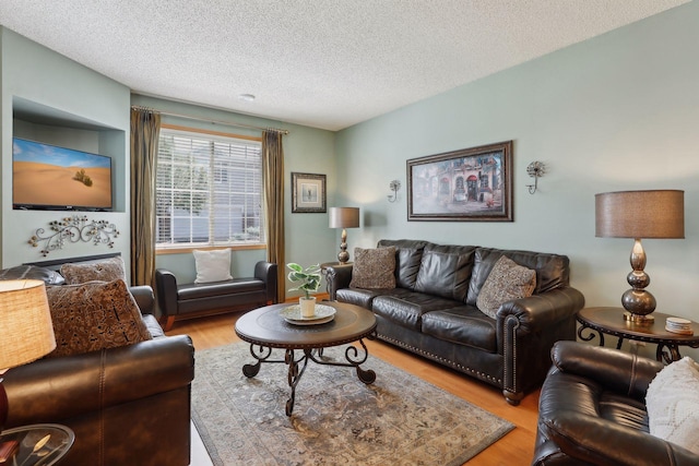 living room featuring light hardwood / wood-style floors and a textured ceiling