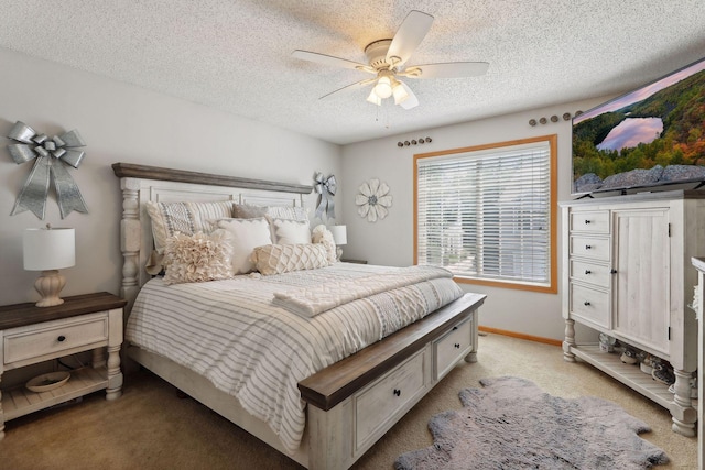 bedroom with ceiling fan, light colored carpet, and a textured ceiling