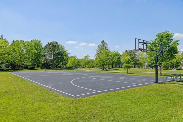 view of basketball court with a yard