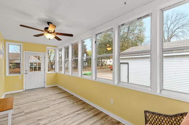 unfurnished sunroom with ceiling fan and a healthy amount of sunlight