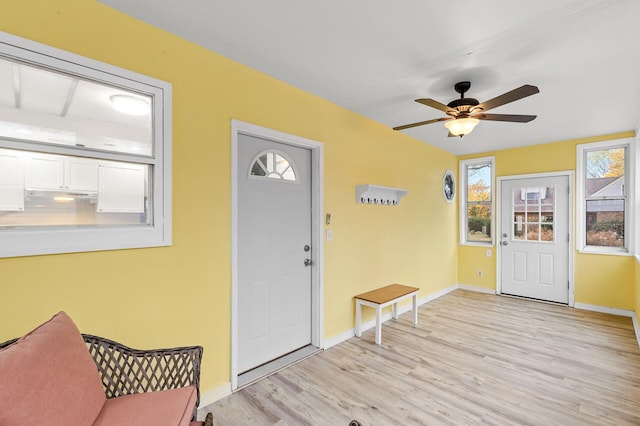 foyer entrance with ceiling fan and light hardwood / wood-style floors