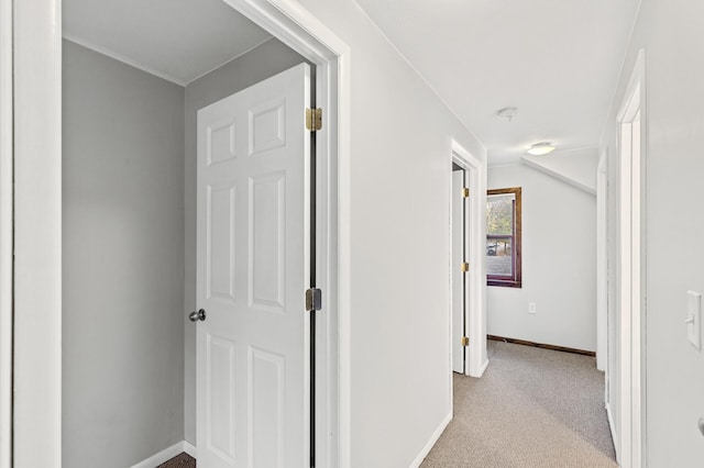 corridor featuring light colored carpet and lofted ceiling