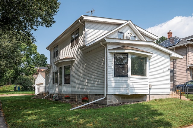 view of side of home featuring a lawn