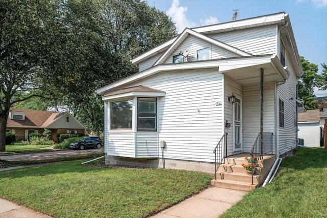 bungalow-style house with a front yard