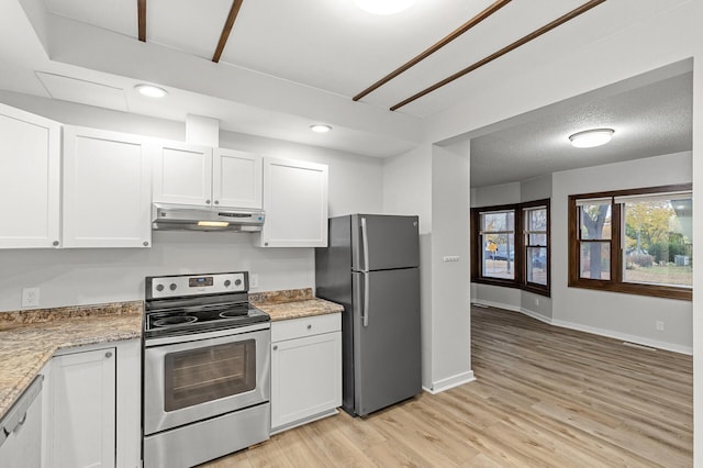 kitchen with white cabinets, light stone counters, stainless steel appliances, a textured ceiling, and light wood-type flooring